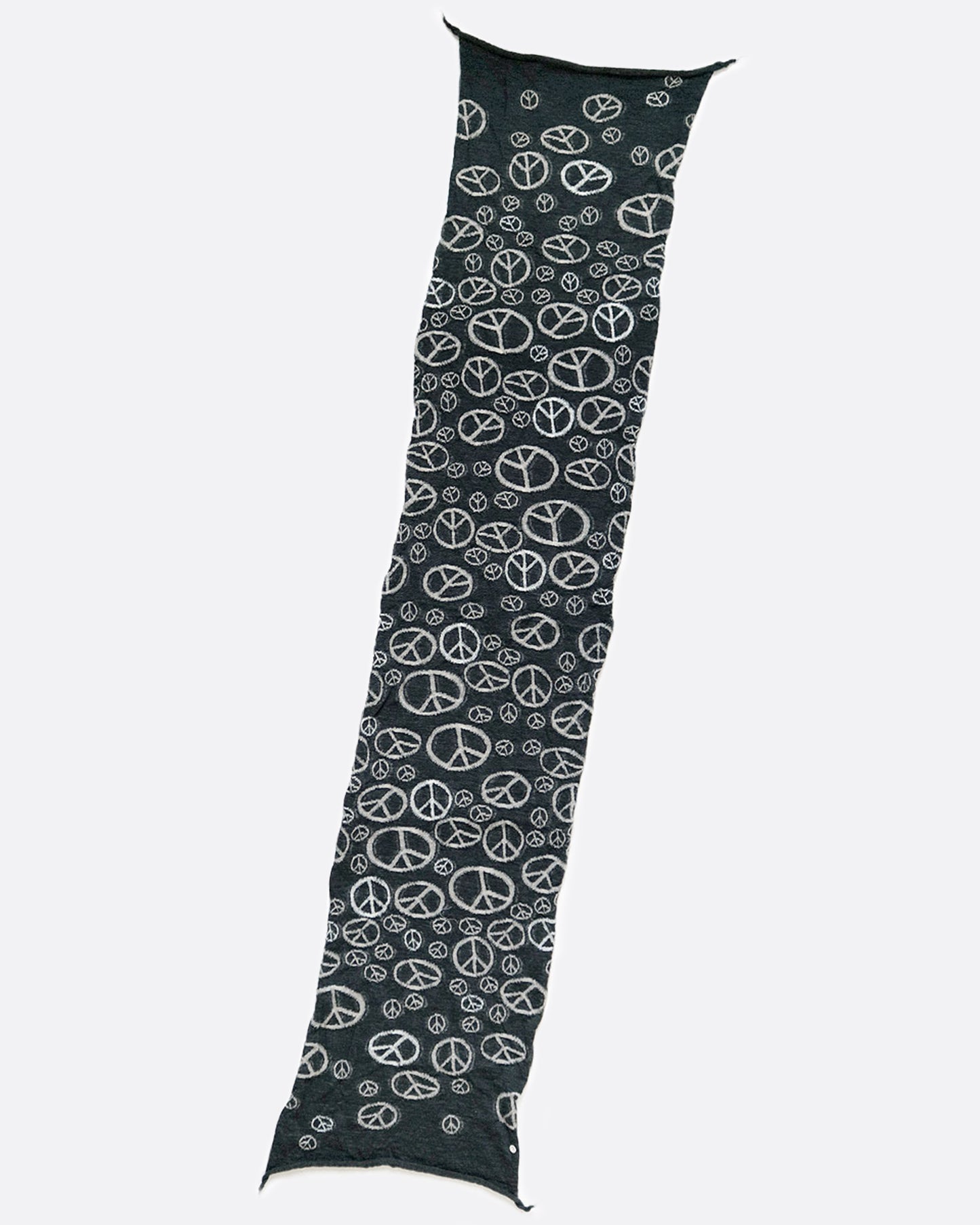 A black wool scarf with white peace signs, shown laying flat.