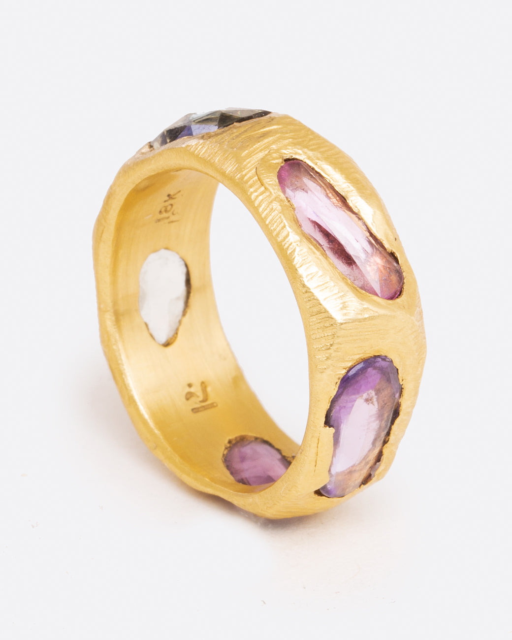 Brushed gold sapphire band with purple sapphires, shown from the side.