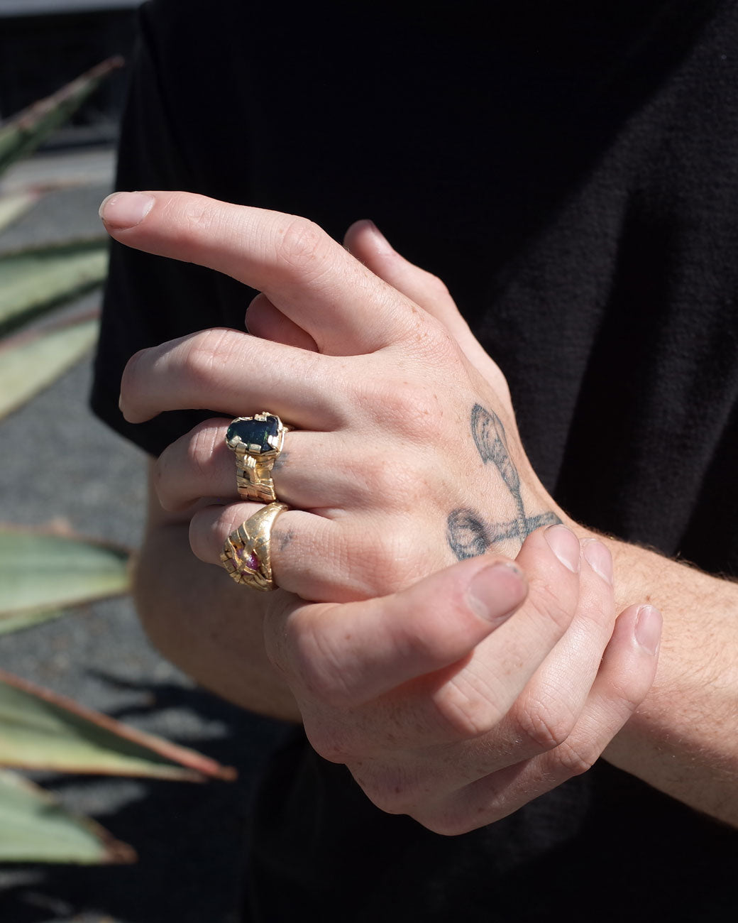 mans hand with the ring on the mans pinky