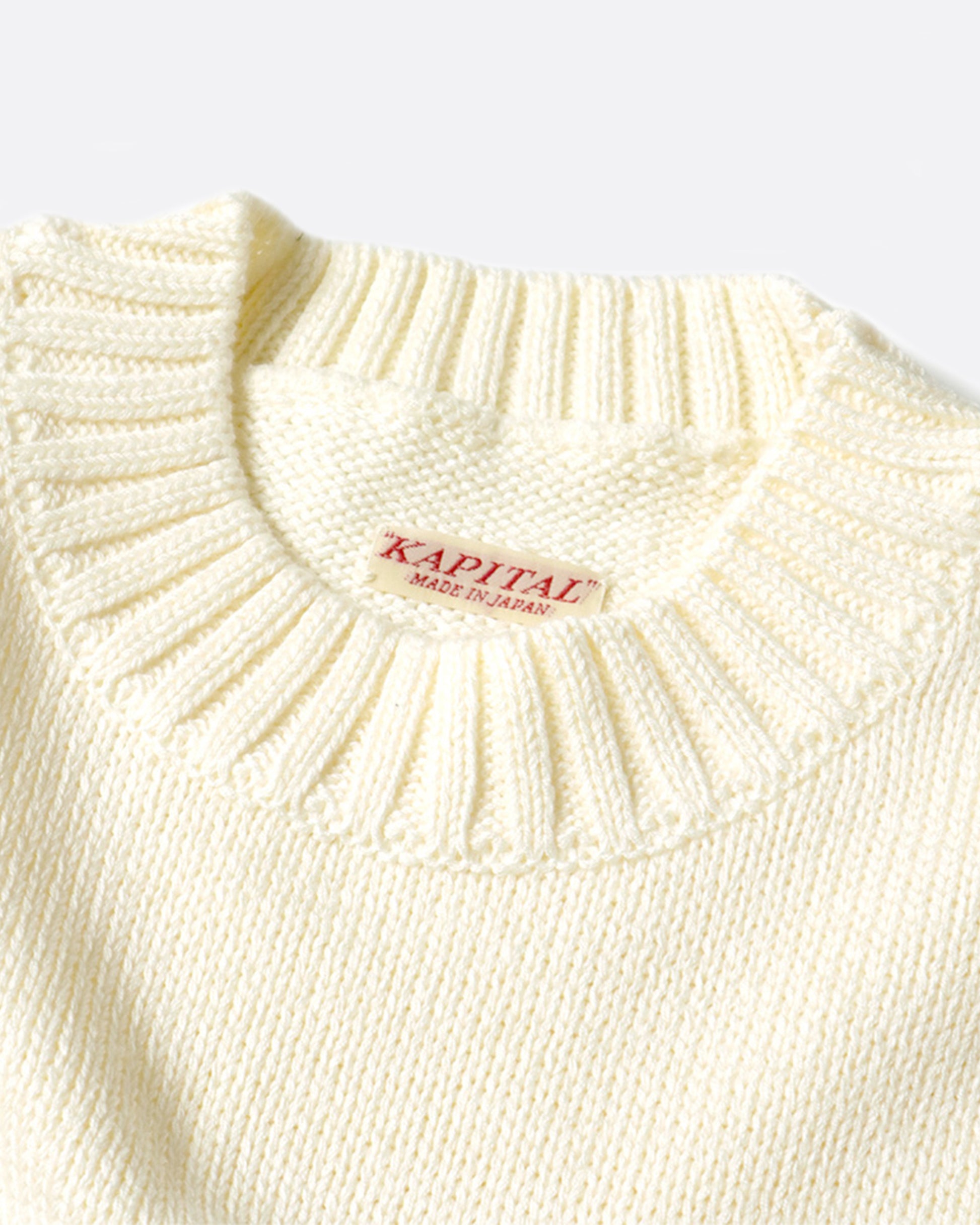 A 5g knit crewneck sweater with a rainbow stripe and smiley elbow patches