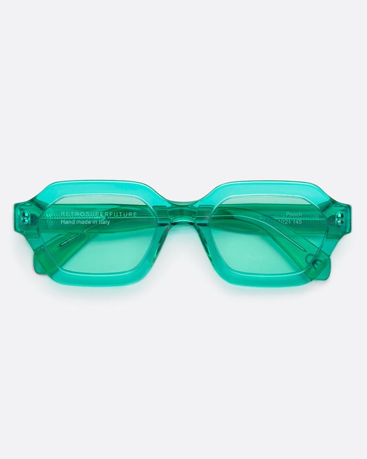 A pair monochromatic, turquoise glasses with transparent, geometric frames.