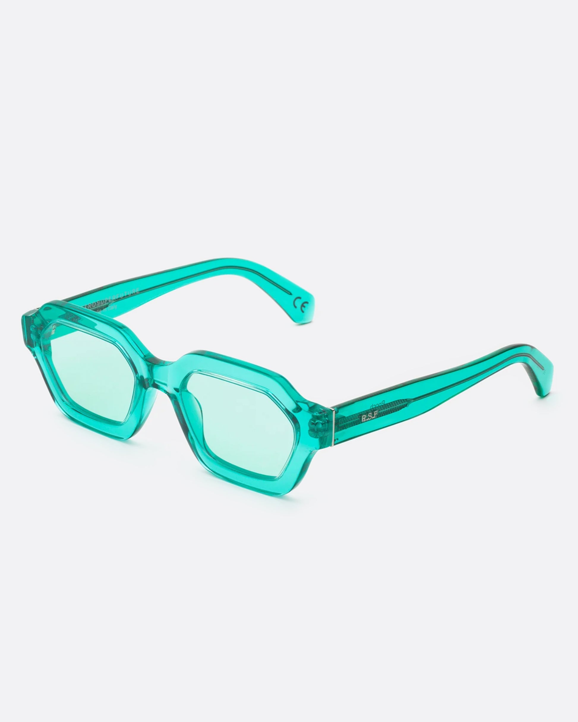 A pair monochromatic, turquoise glasses with transparent, geometric frames.
