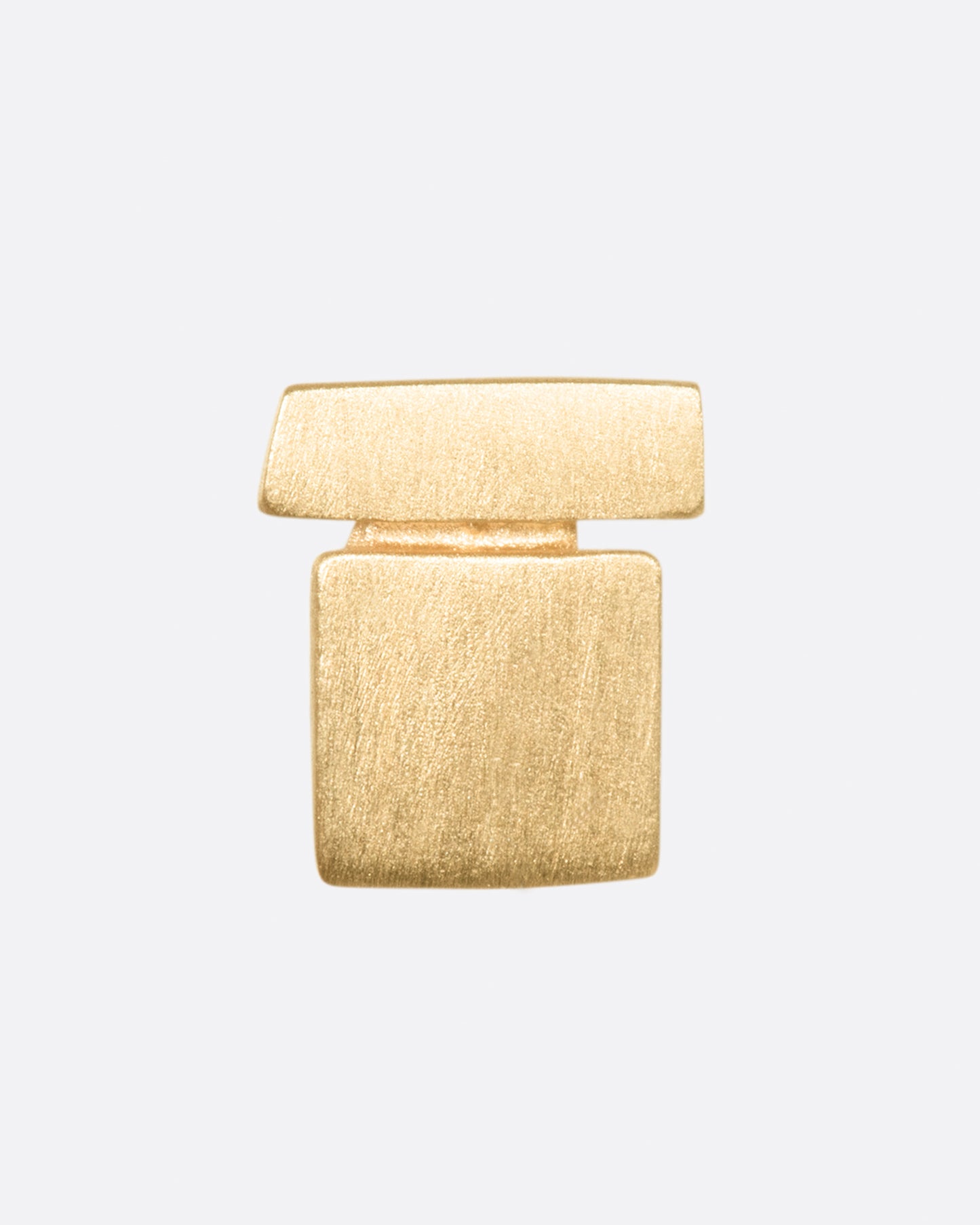 A yellow gold stacked geometric stud earring with matte finish. 