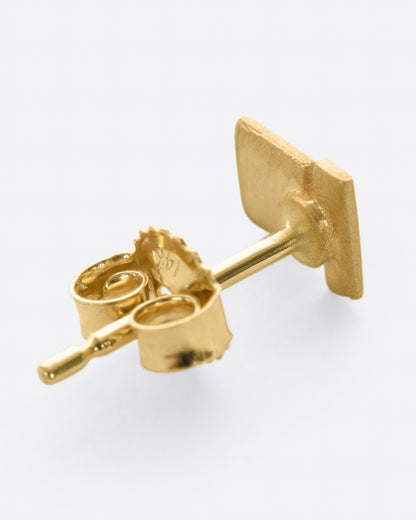 A matte finished yellow gold stud earring with two rectangles stacked. Shown lying flat from the back.