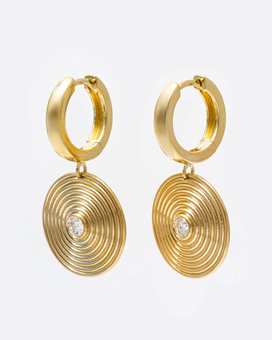 14k yellow gold hoop earrings with round ribbed diamond drops by Selin Kent, shown from the side.