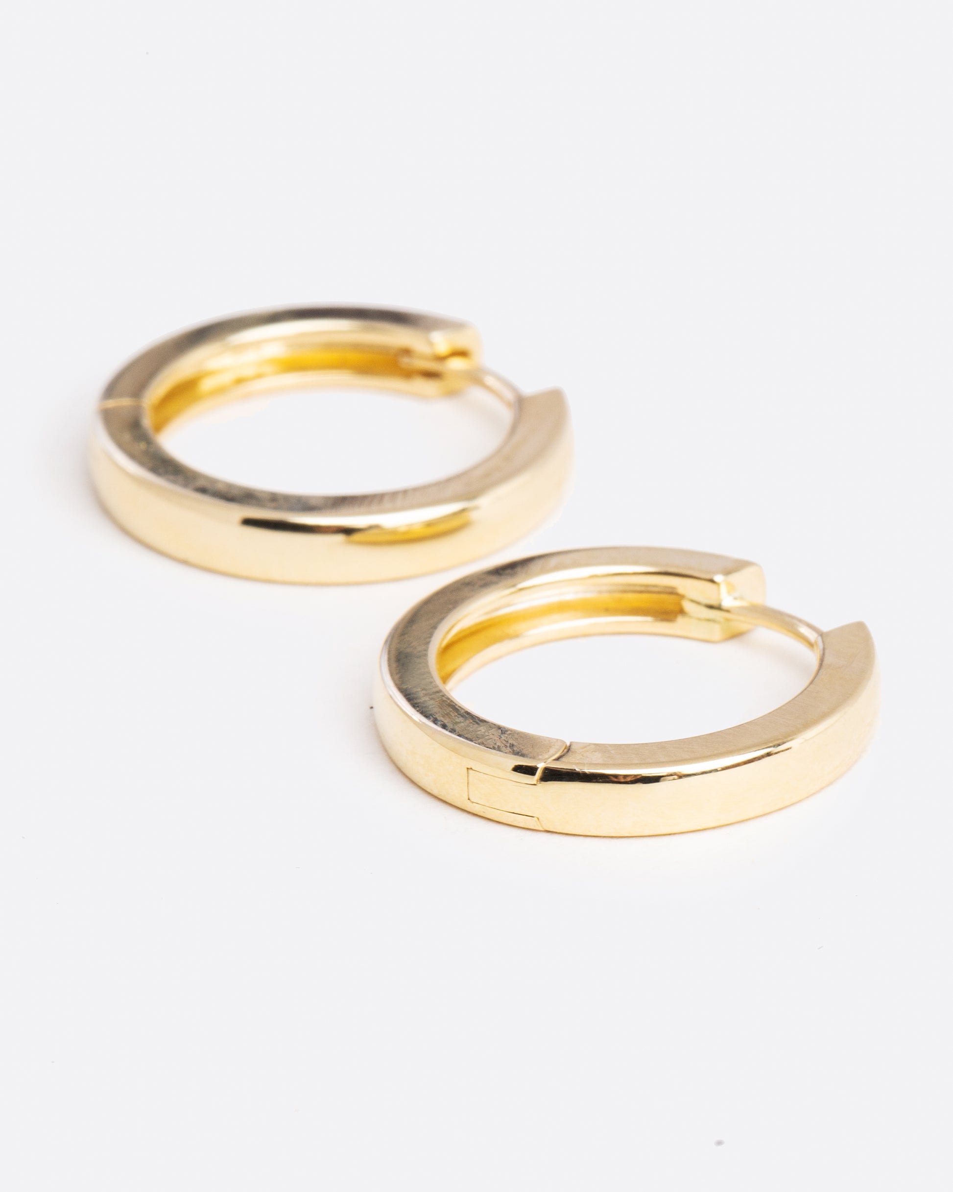 angled view of yellow gold hoop earrings