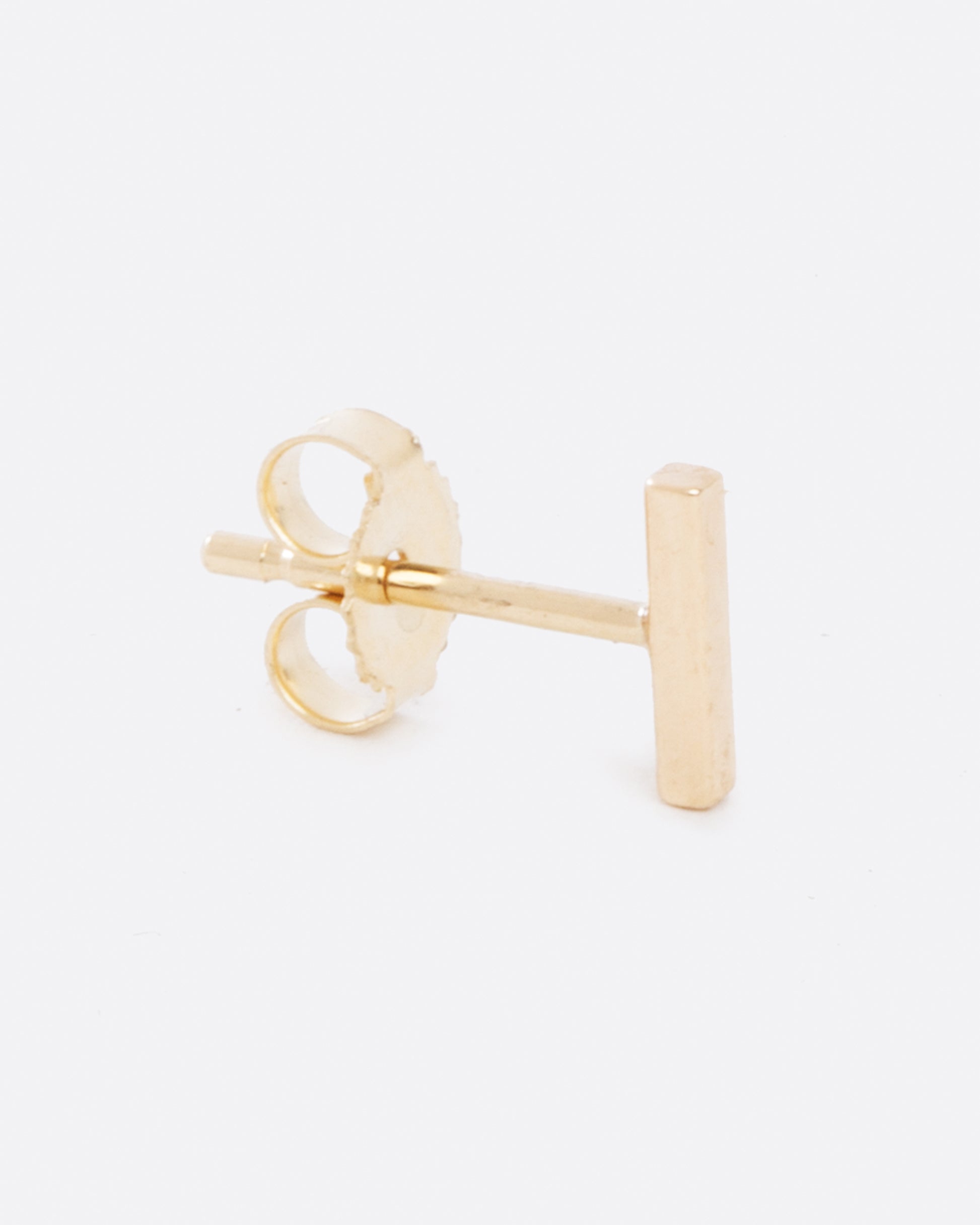 14k yellow gold bar earring by Selin Kent, shown from the side.
