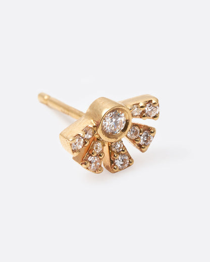 A yellow gold earring in the shape of a sun with rays with diamonds inlaid throughout. Shown diagonally from the front.