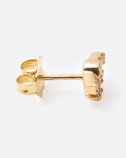 A yellow gold earring in the shape of a sun with rays with diamonds inlaid throughout. Shown from the side.