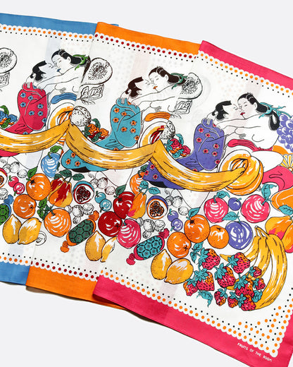 Three colorful bandanas, one with a blue edge, one with an orange, and one with a red. Each with a spring painting print of lovers embracing among a spread of fruits. Shown layered lying flat.