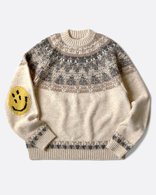 A crewneck pullover sweater with a Nordic pattern around the shoulders and smiley faces on the elbows, shown laying flat.