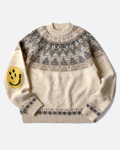 A crewneck pullover sweater with a Nordic pattern around the shoulders and smiley faces on the elbows, shown lying flat from the front.