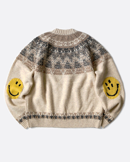 A crewneck pullover sweater with a Nordic pattern around the shoulders and smiley faces on the elbows, shown lying flat from the back.