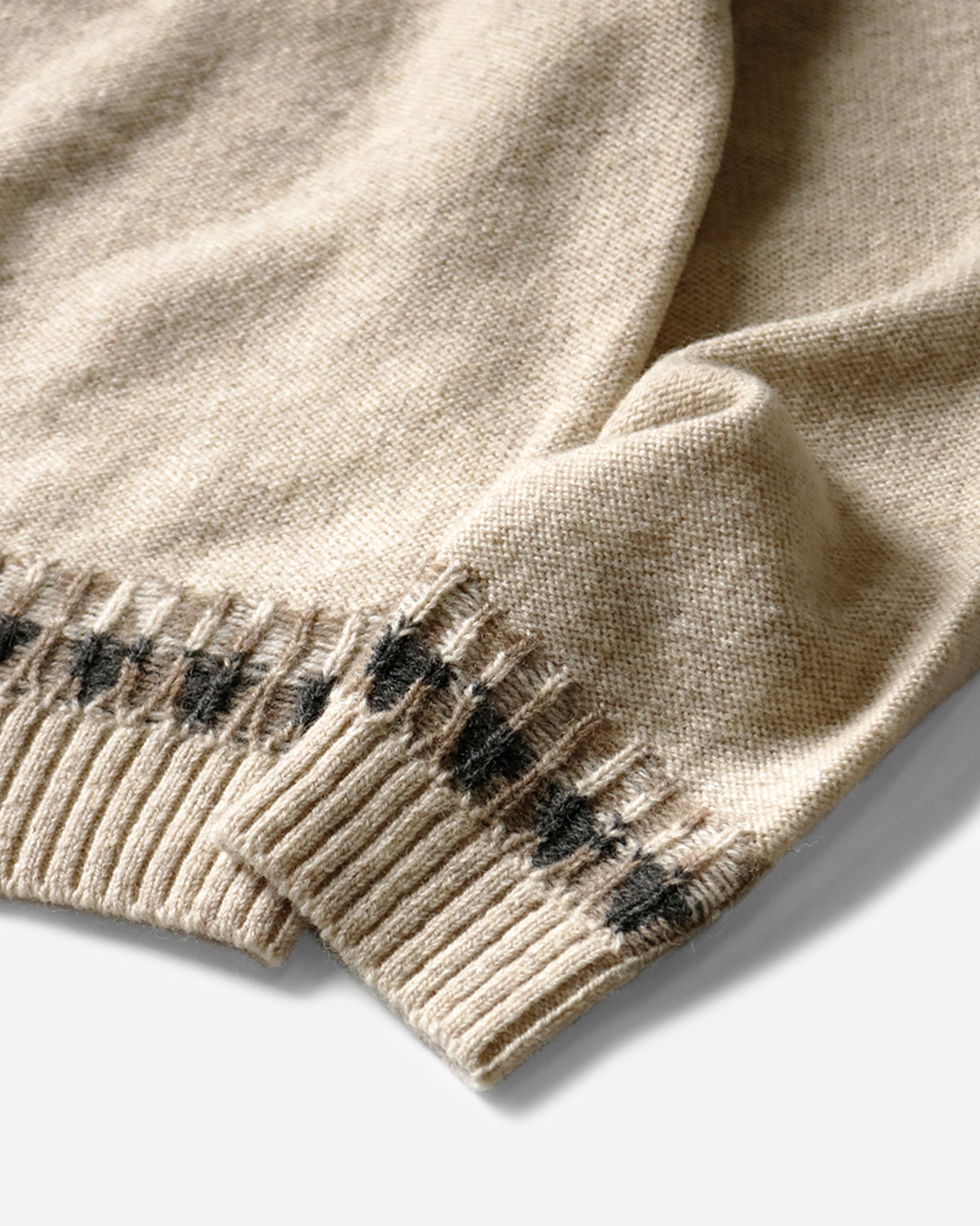 A close up on the sleeves of the Nordic smiley sweater.
