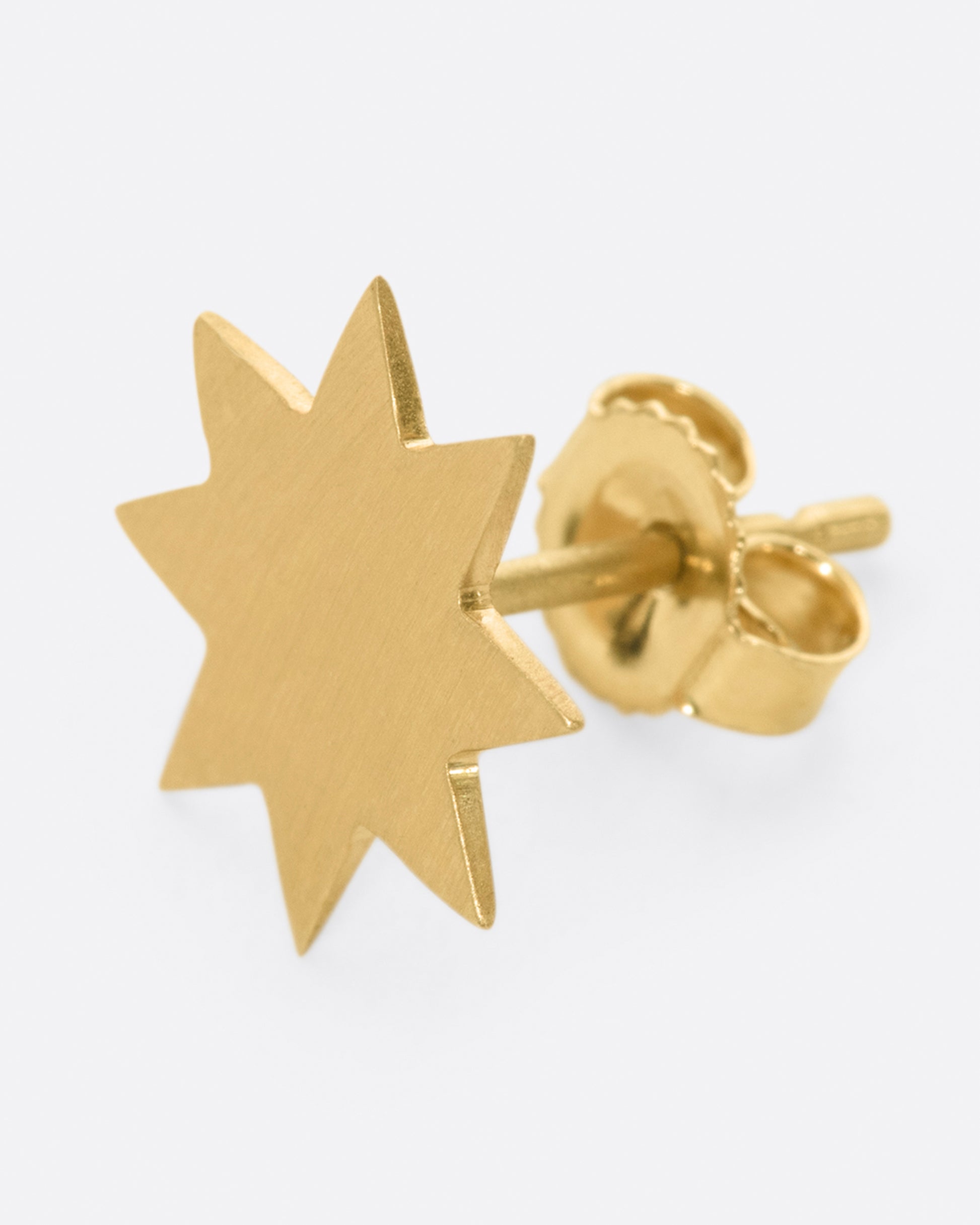 A round, matte star earring; perfectly paired with another star of a different color.