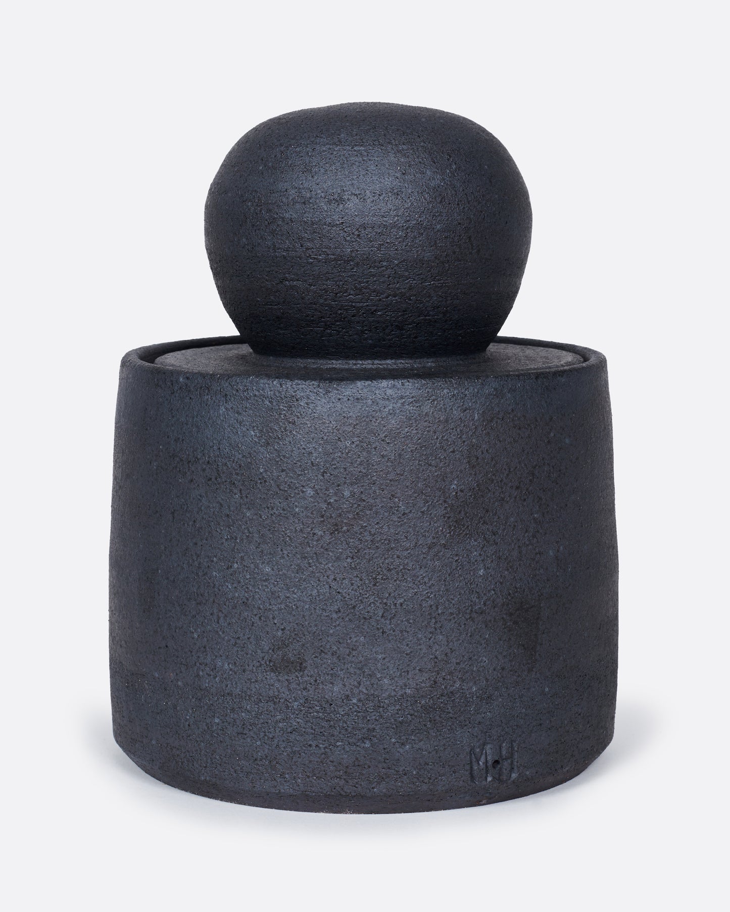 A black jar with a globe lid, shown from the front.
