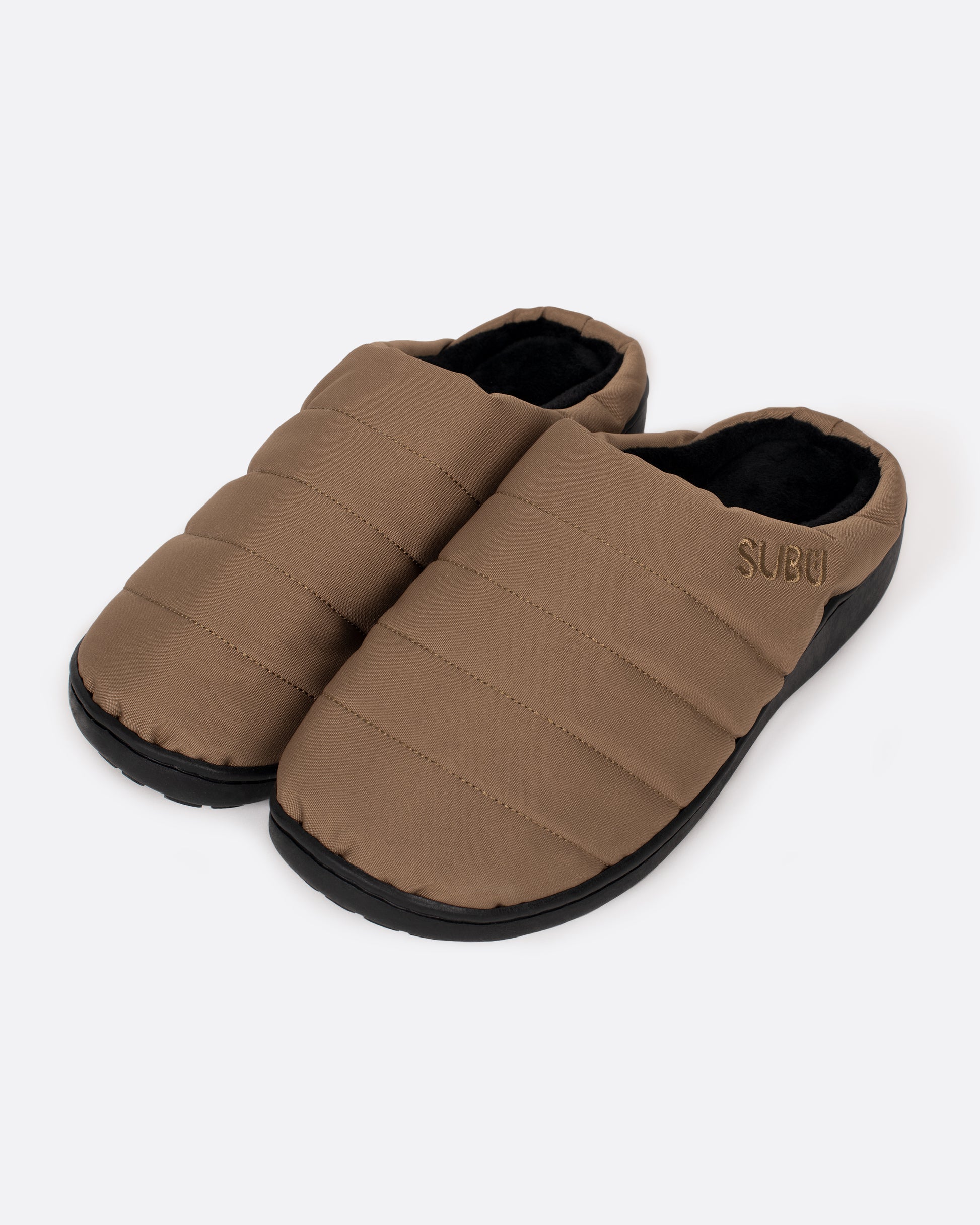 A pair of tan nylon slippers with black rubber soles, shown from the side.