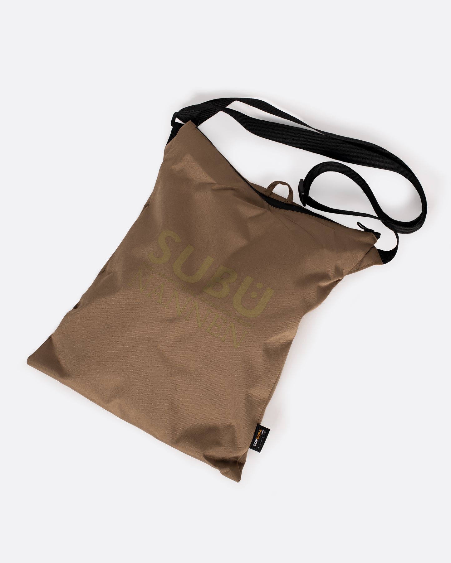 A tan nylon bag with a black strap that is used to carry slippers.