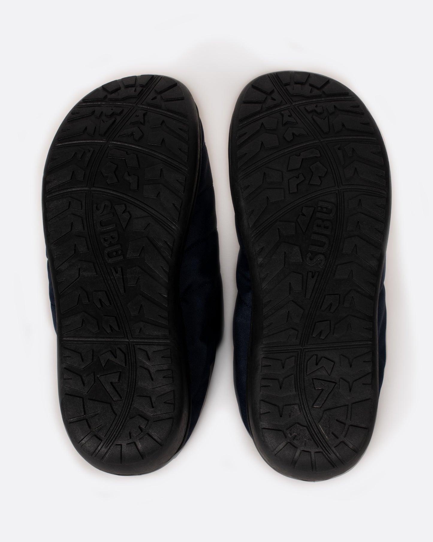 Black rubber soles of Subu slippers.