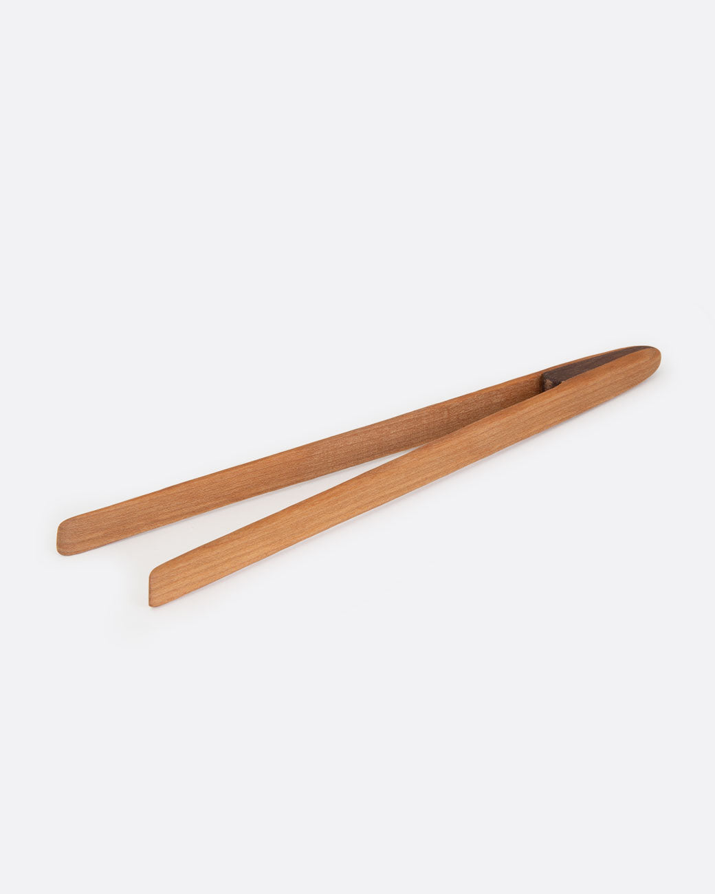Cherry wood magnetic toaster tongs, shown from the side.