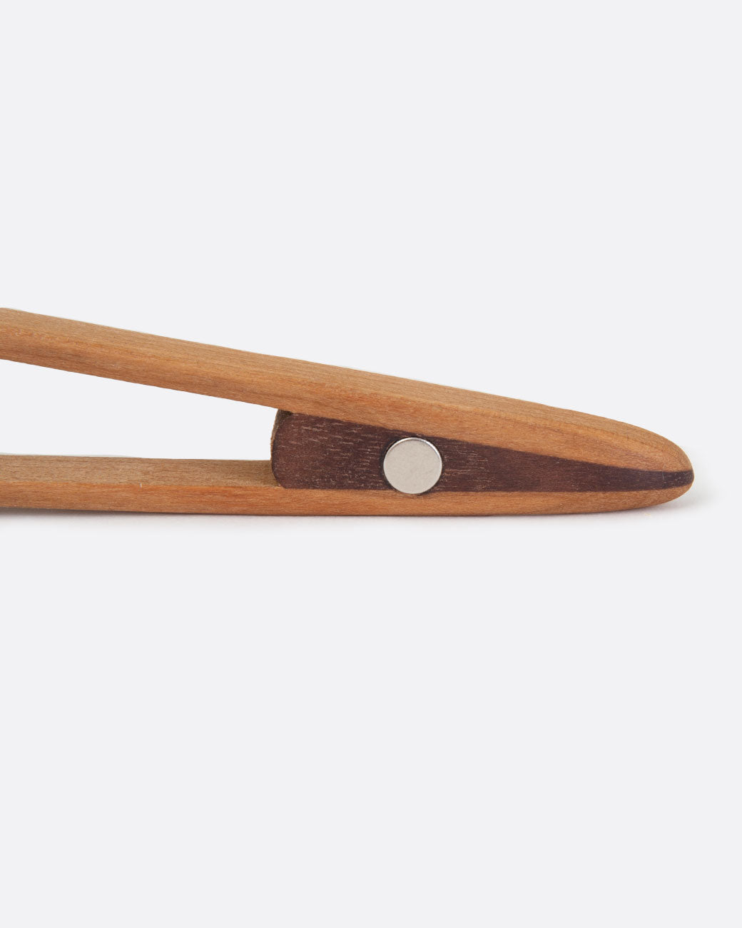 Close up of cherry wood magnetic toaster tongs.