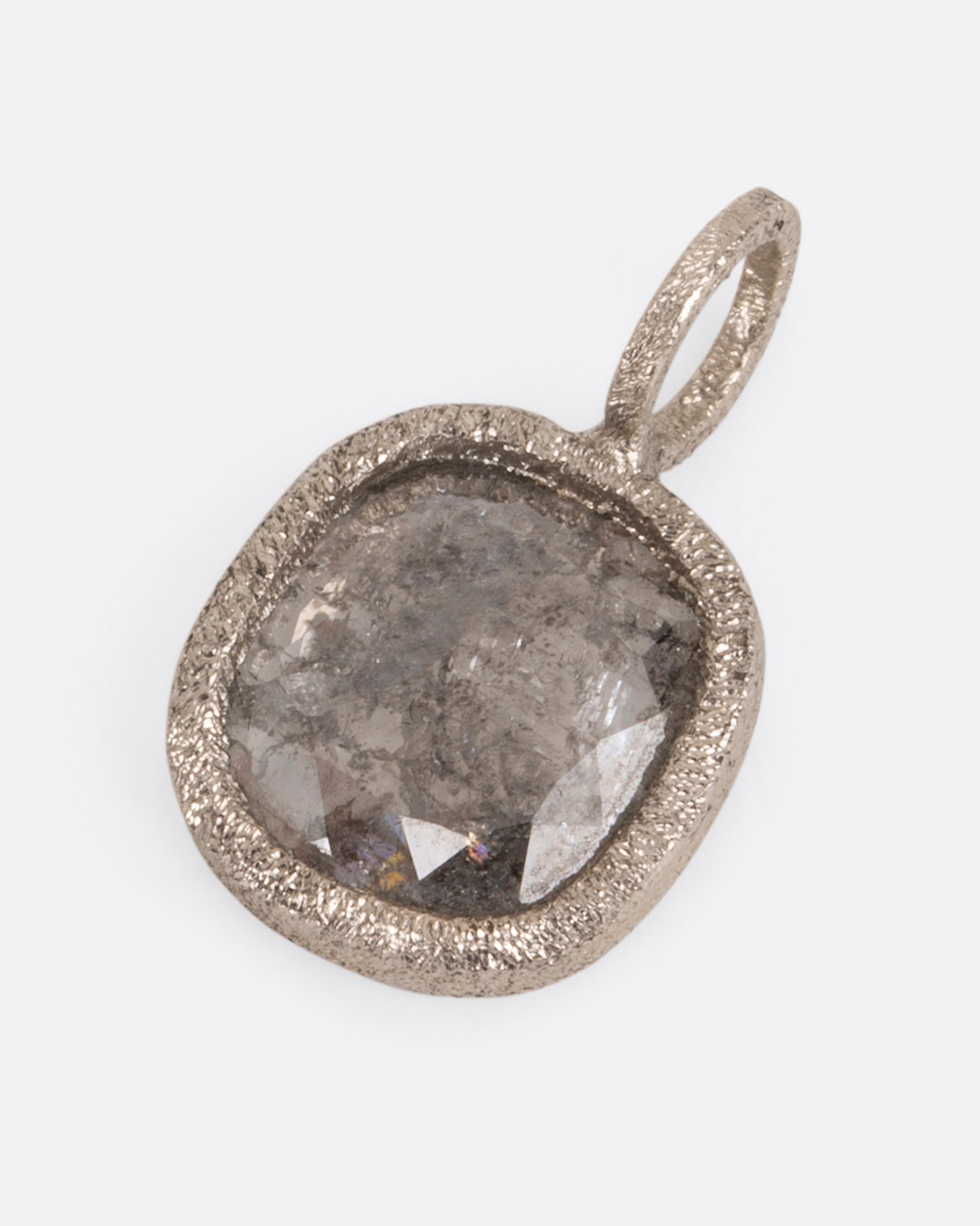 A pendant with a square salt and pepper diamond set in white gold.