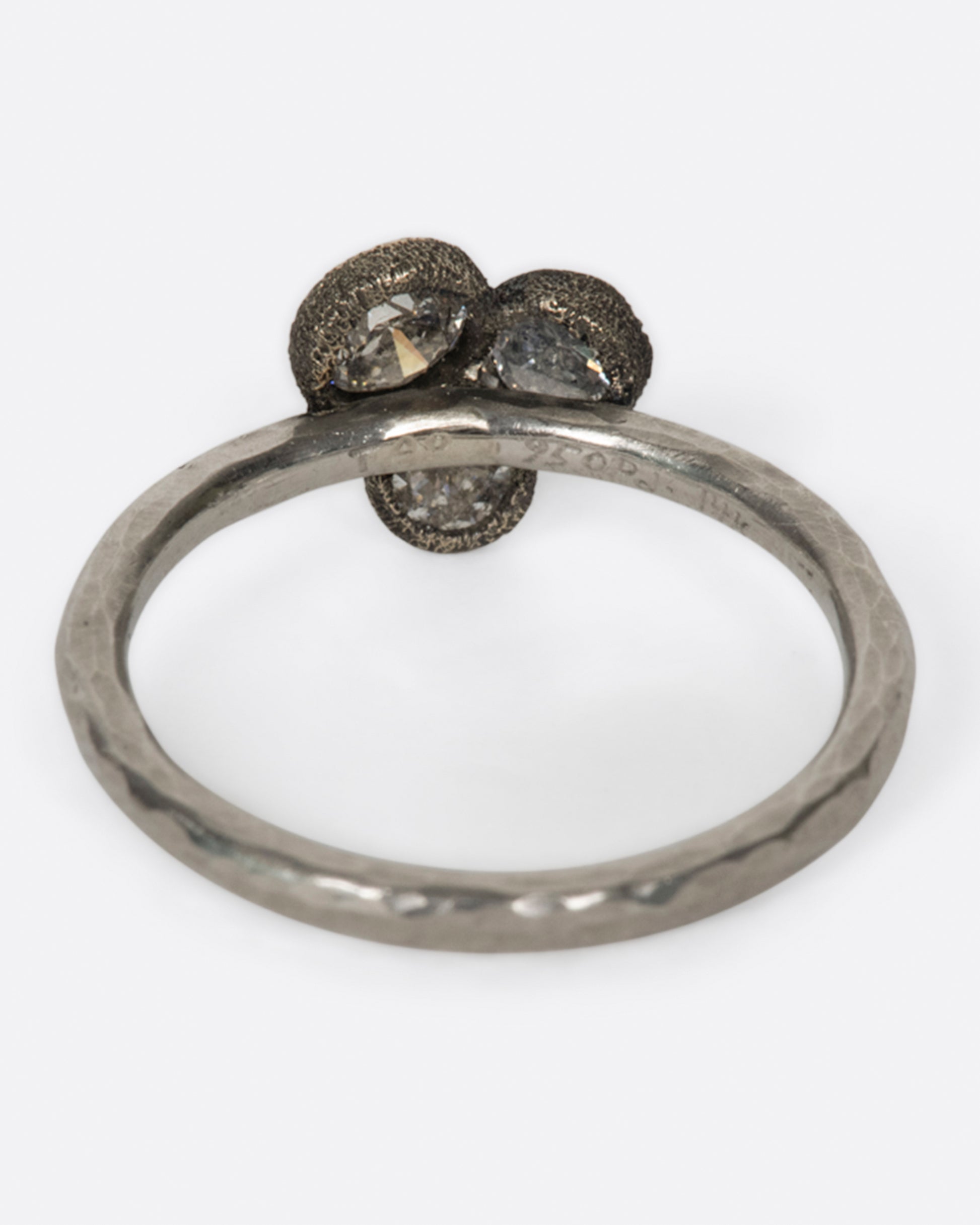 A hammered narrow palladium band with three inverted diamonds clustered in the center, shown from the back.