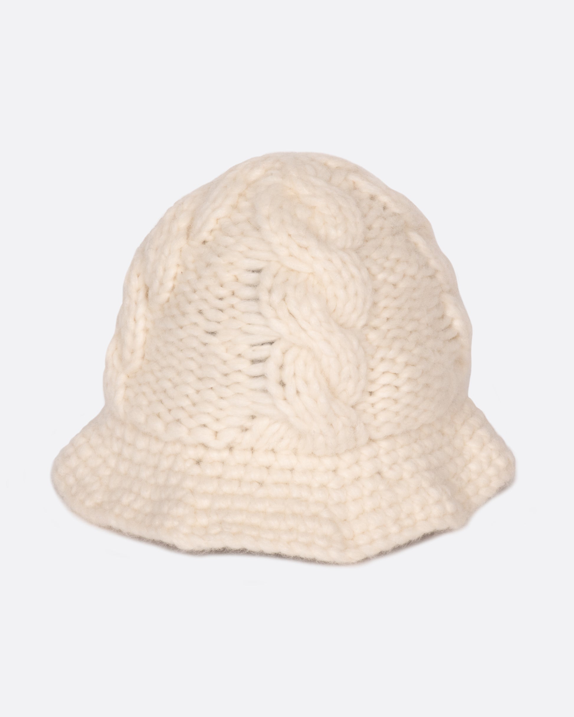 A chunky cable knit bucket hat with a narrow brim.
