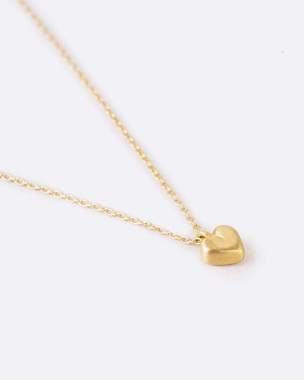 simple gold heart pendant on a thin yellow gold chain