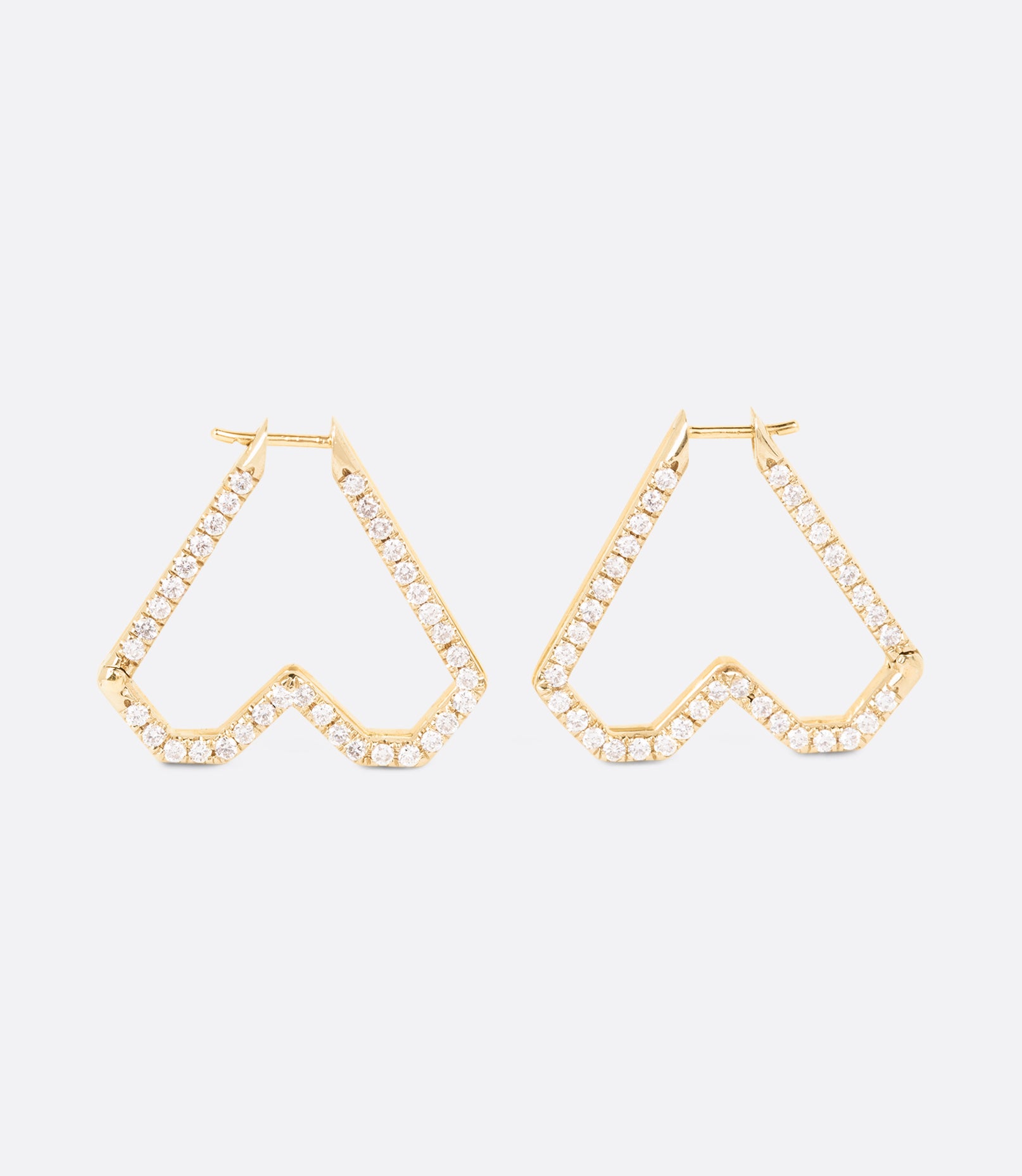 Two-tone 14k yellow and white gold heart hoops lined with beautiful pave diamonds.Two-tone 14k yellow and white gold heart hoops lined with beautiful pave diamonds.