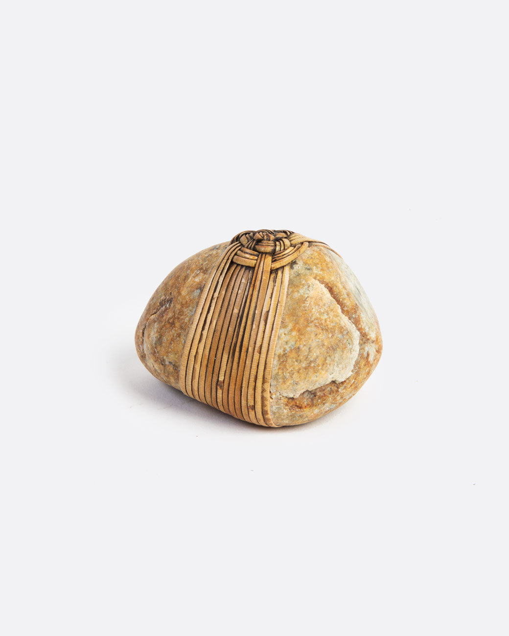 image of a blessing stone, wrapped in a woven grass. 