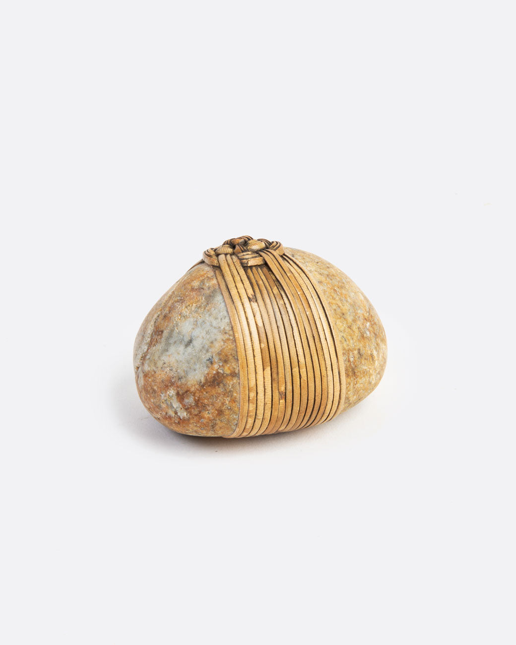 image of a blessing stone, wrapped in a woven grass. 