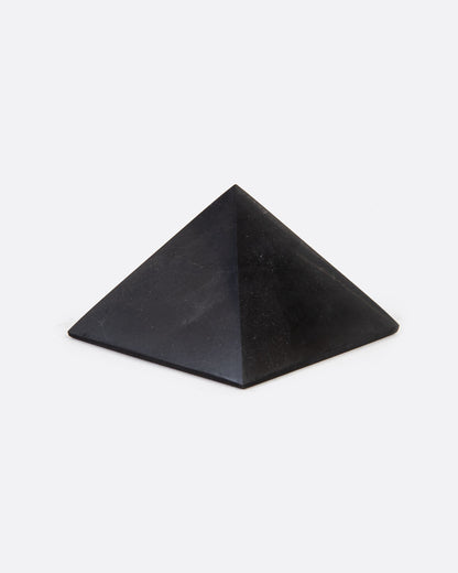 A black stone pyramid. Shown sitting flat at an angle.