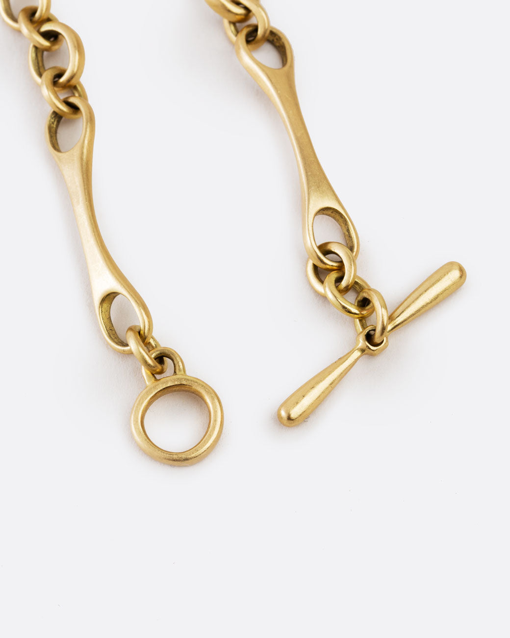 close up of the toggle clasp on the matte gold bracelet