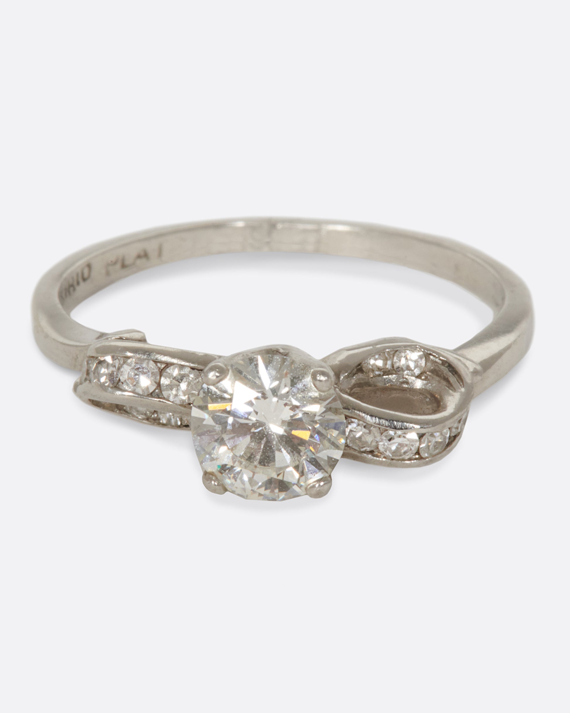 A prong set diamond ring with an infinity loop, covered in tension-set diamonds.