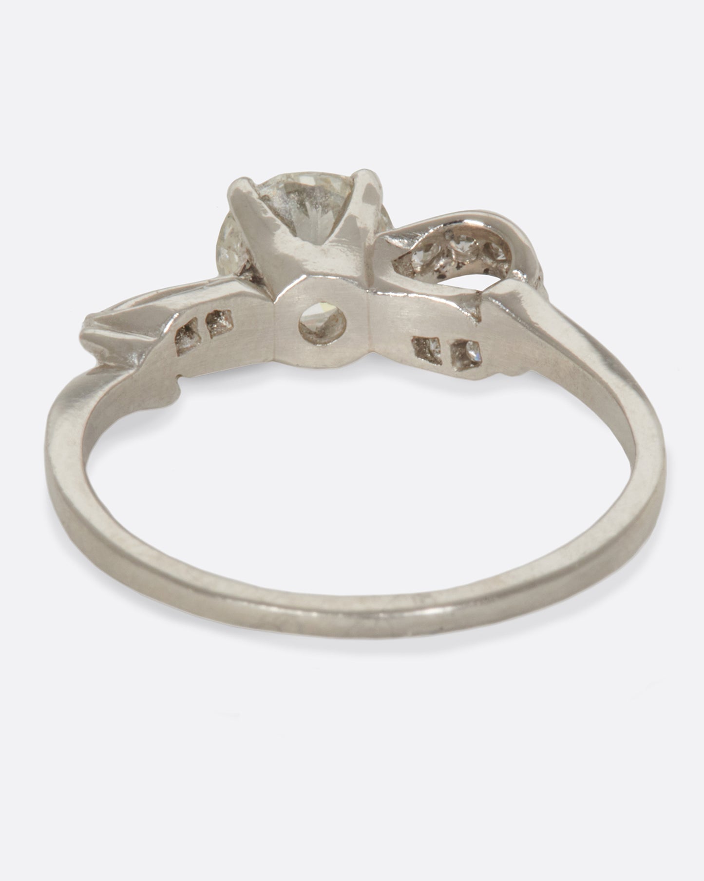 A prong set diamond ring with an infinity loop, covered in tension-set diamonds.