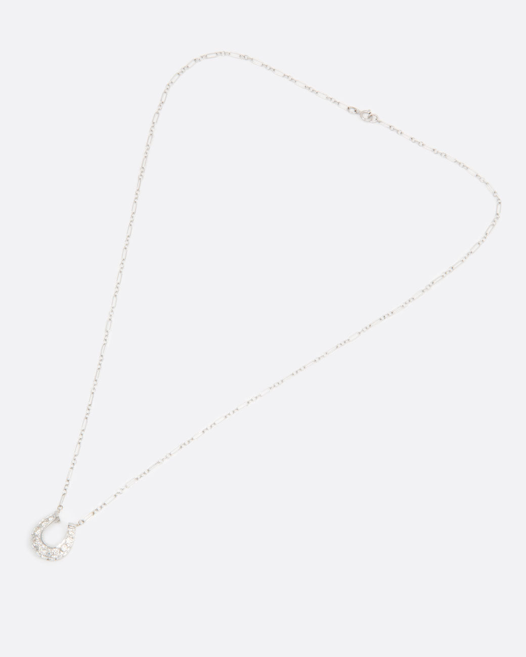 Diamond horseshoe necklace, shown laying flat.