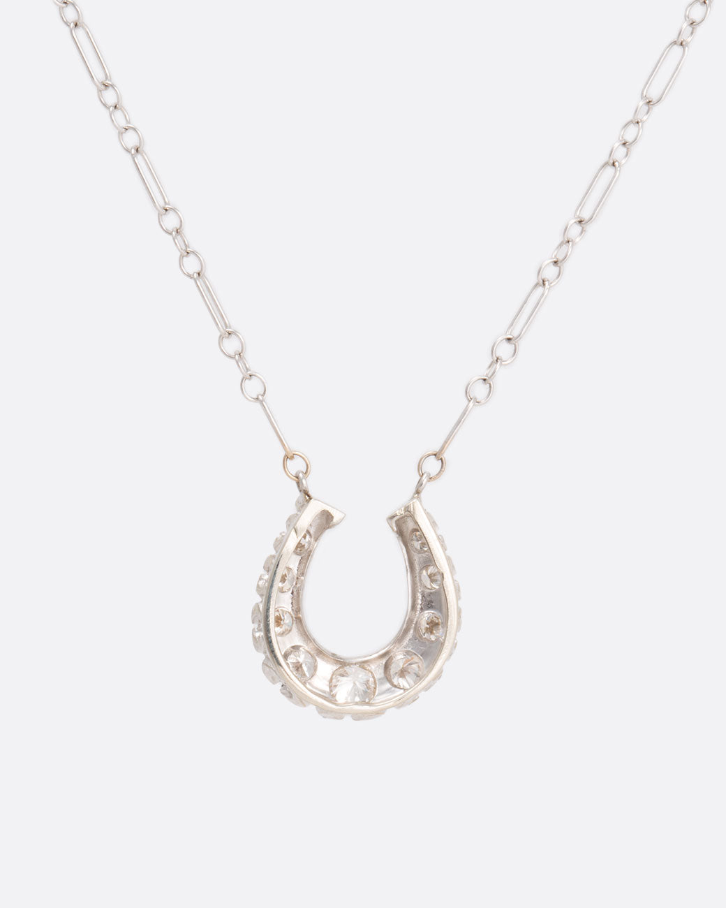 Diamond horseshoe necklace, shown from behind.
