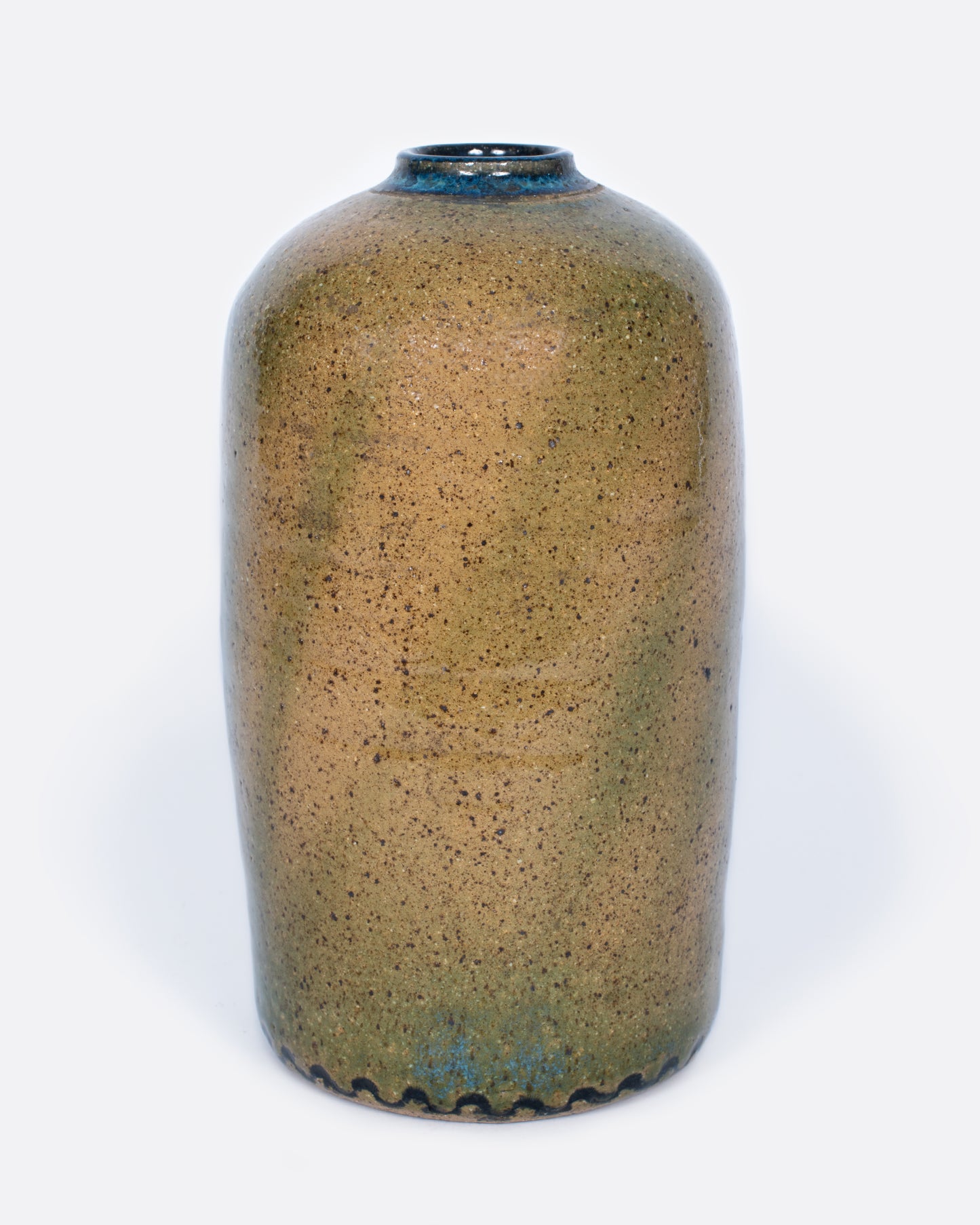 A cylindrical brown vase with swirls of blue and green glaze.