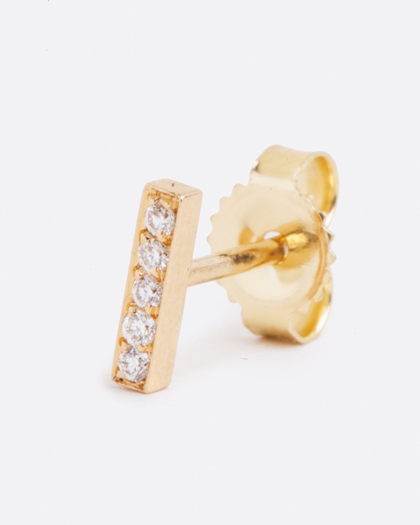 14k yellow gold bar stud earring with five white diamonds by Selin Kent, shown from the front.