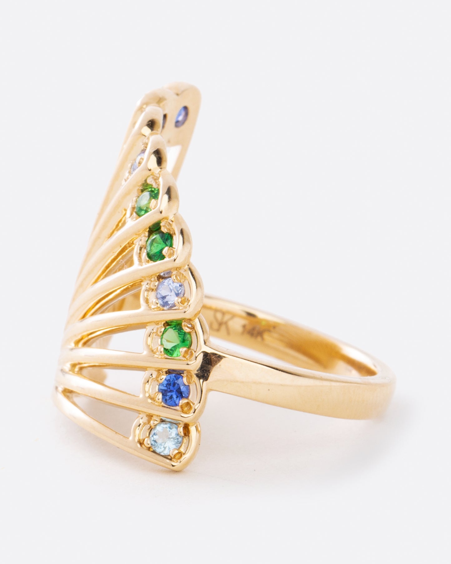 side view of fan shaped ring with large multicolor sapphires along the edge