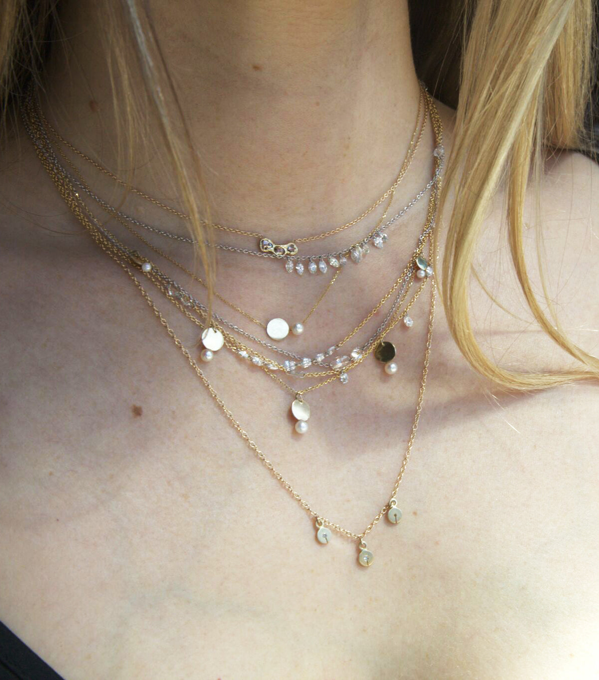 womans neck with layers of necklaces including the trio necklace